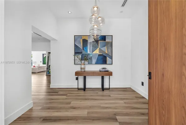 a view of a livingroom with hardwood floor and a ceiling fan