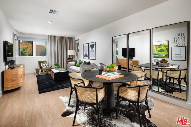 a view of a livingroom with furniture and a large window