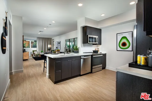 a kitchen with stainless steel appliances granite countertop a stove and a refrigerator