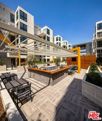 a roof deck with a table and chairs