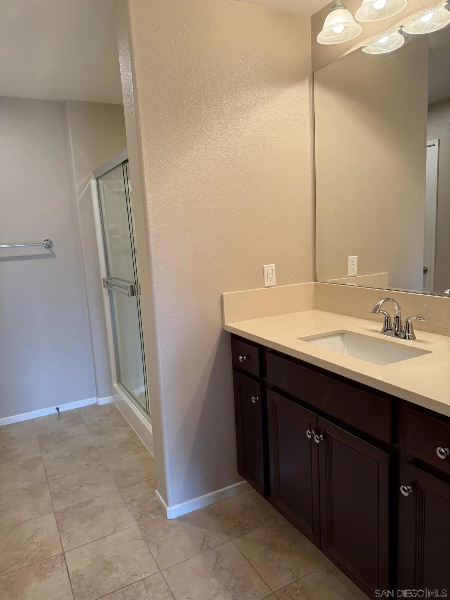 11130 Taloncrest Way, Unit 13 San Diego, CA 92126 - Photo 9 of 11 a bathroom with a sink a mirror and a shower