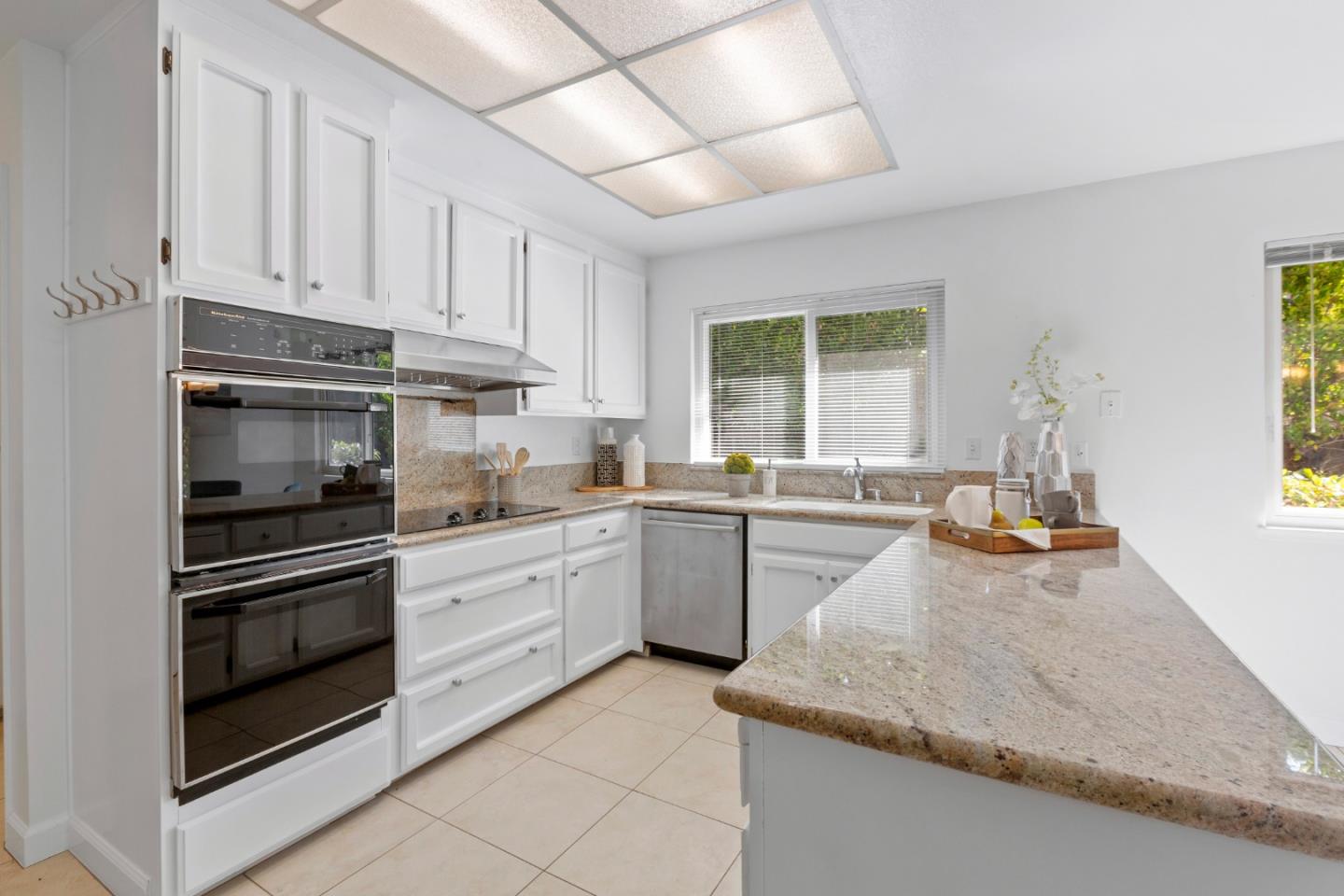 244 Delphi Circle Los Altos, CA 94022 - Photo 13 of 61 a kitchen with granite countertop white cabinets and appliances