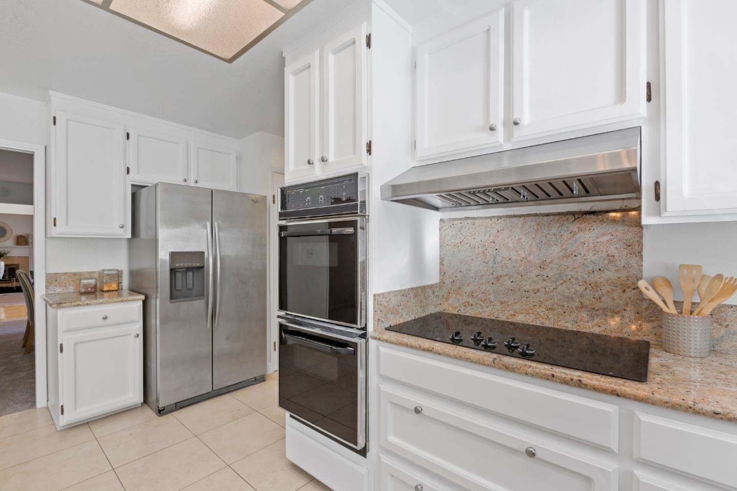 244 Delphi Circle Los Altos, CA 94022 - Photo 15 of 61 a kitchen with white cabinets and stainless steel appliances