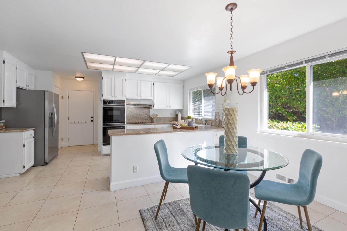 244 Delphi Circle Los Altos, CA 94022 - Photo 18 of 61 a kitchen with stainless steel appliances granite countertop a stove a refrigerator a kitchen island a table and chairs