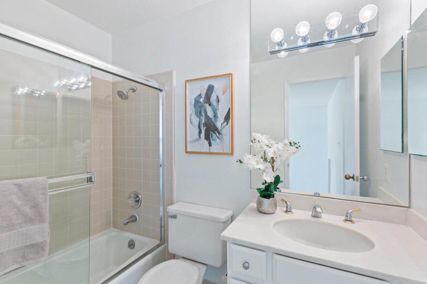 244 Delphi Circle Los Altos, CA 94022 - Photo 39 of 61 a bathroom with a sink a toilet a shower a mirror and a bathtub
