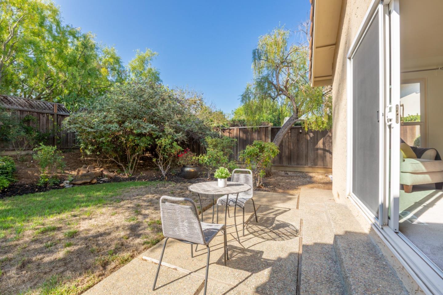 244 Delphi Circle Los Altos, CA 94022 - Photo 48 of 61 a view of a patio with table and chairs potted plants with wooden floor and fence