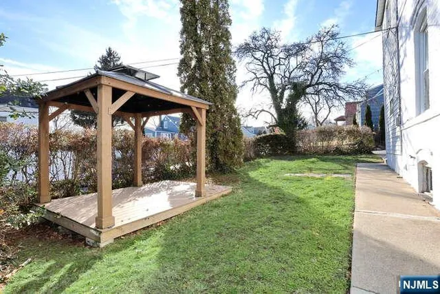 a view of a wooden deck with a backyard