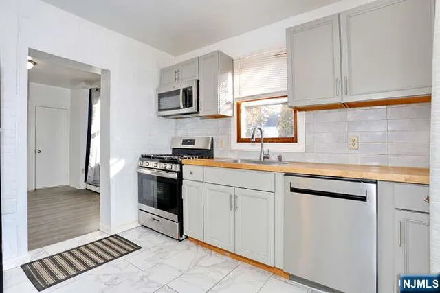 a kitchen with stainless steel appliances granite countertop a sink and cabinets