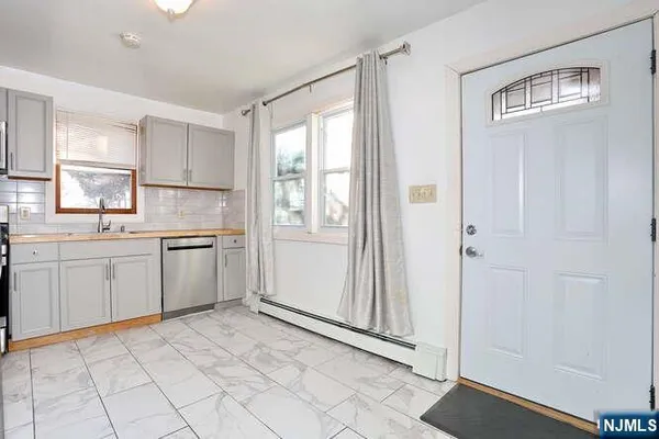 a kitchen with white cabinets and white appliances