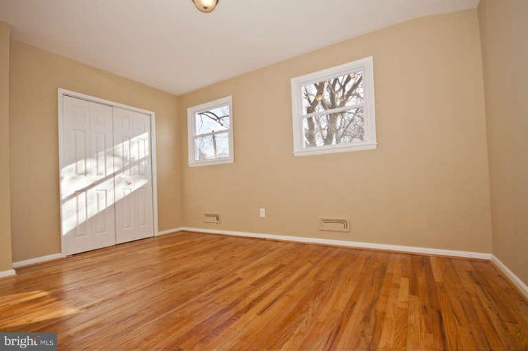 3502 Sedgemoor Road Baltimore, MD 21207 - Photo 22 of 29 a view of an empty room with wooden floor and a window