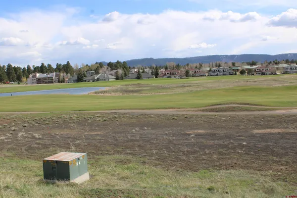 a view of a lake with houses in the back
