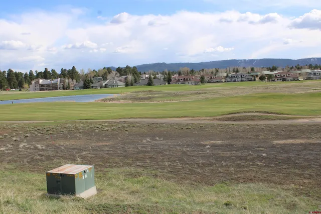 a view of a lake with houses in the back