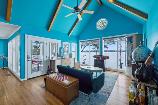 a living room with furniture and a floor to ceiling window