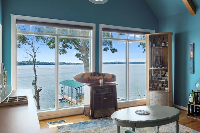 a kitchen with stainless steel appliances kitchen island granite countertop a stove a sink dishwasher and a refrigerator with wooden floor