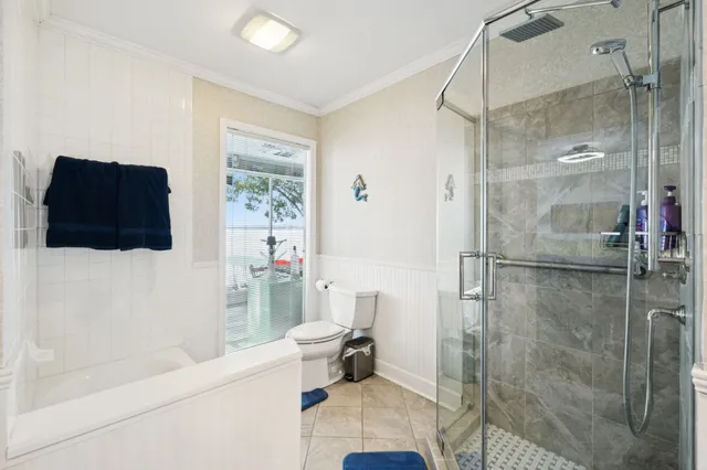 a view of a bedroom with furniture and a window
