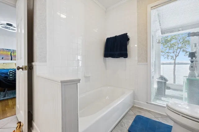 a bedroom with furniture and a flat screen tv