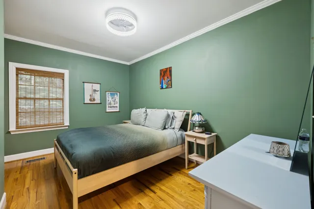 a bedroom with a bed and large windows