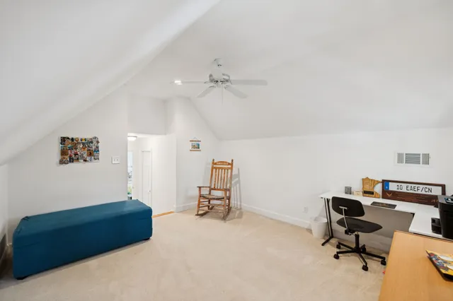 a view of a house with swimming pool and sitting area