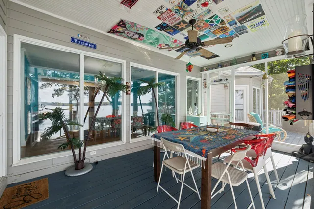 a view of backyard with seating space and trees in the background