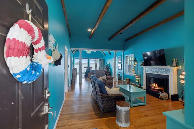 a living room with furniture a fireplace and a flat screen tv