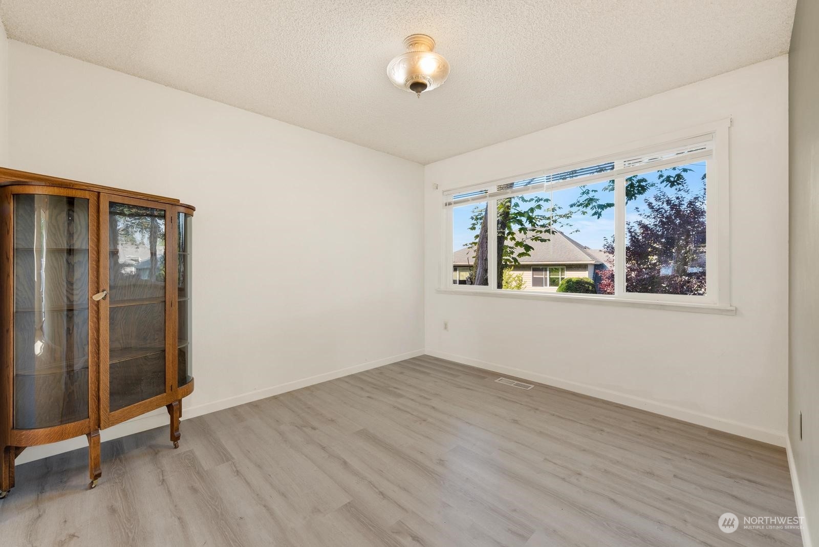 2102 240th Place Southeast Bothell, WA 98021 - Photo 4 of 20 an empty room with wooden floor and window