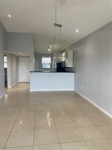 a view of a kitchen with a sink and cabinets