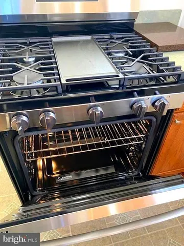 a stove top oven sitting inside of a kitchen