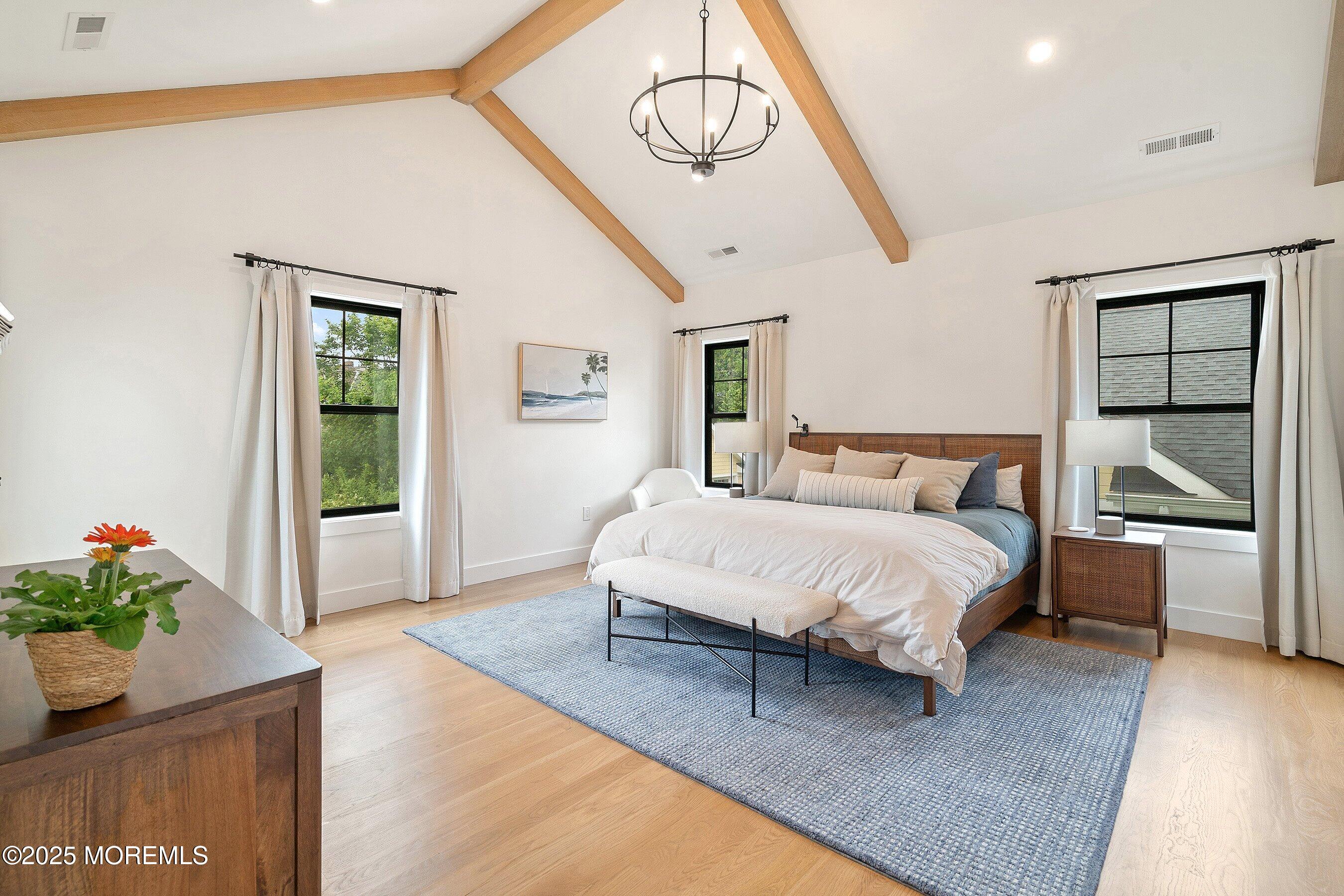 405 Ludlow Avenue Spring Lake, NJ 07762 - Photo 22 of 42 a spacious bedroom with a bed and a window