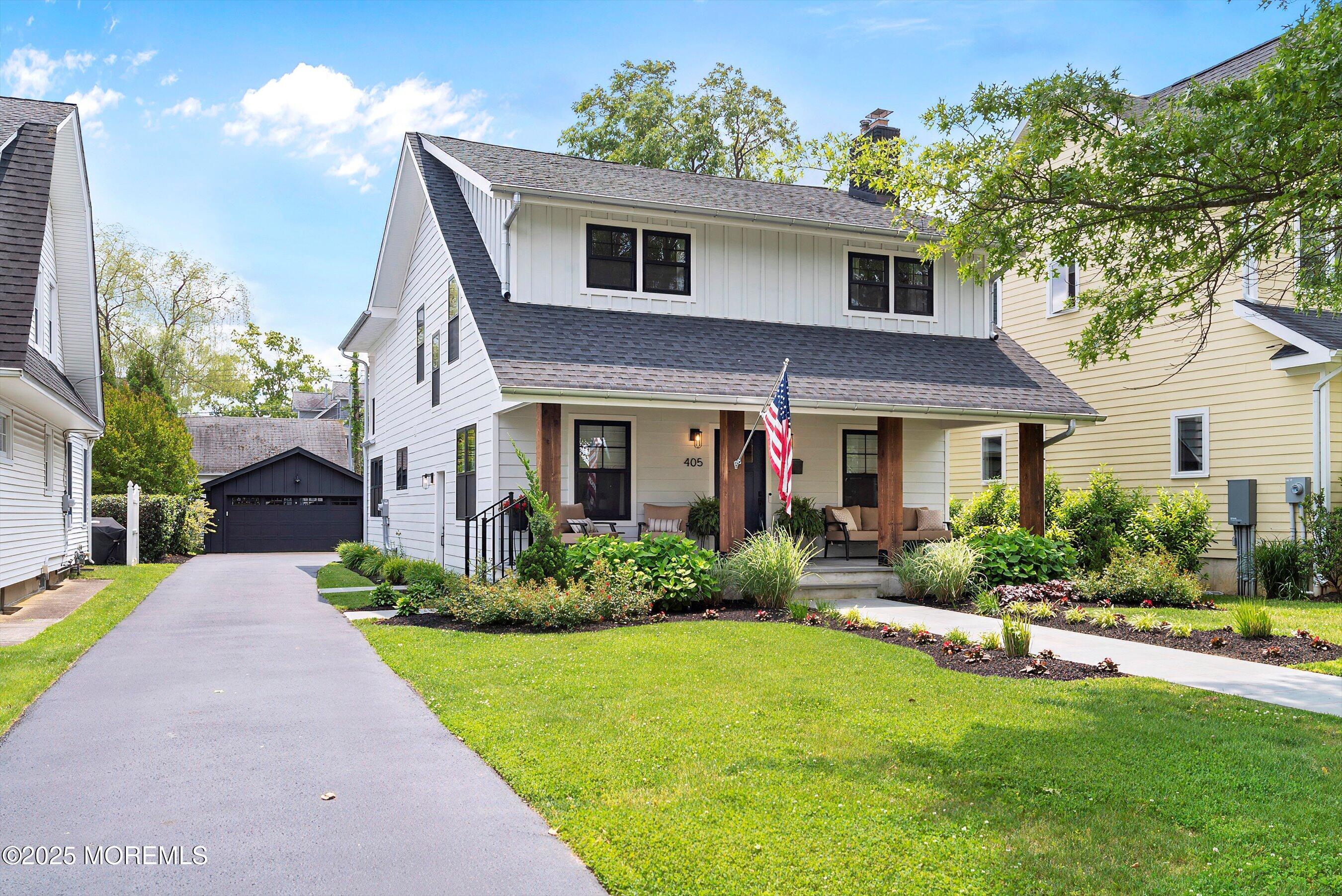 405 Ludlow Avenue Spring Lake, NJ 07762 - Photo 3 of 42 a front view of a house with a yard and potted plants