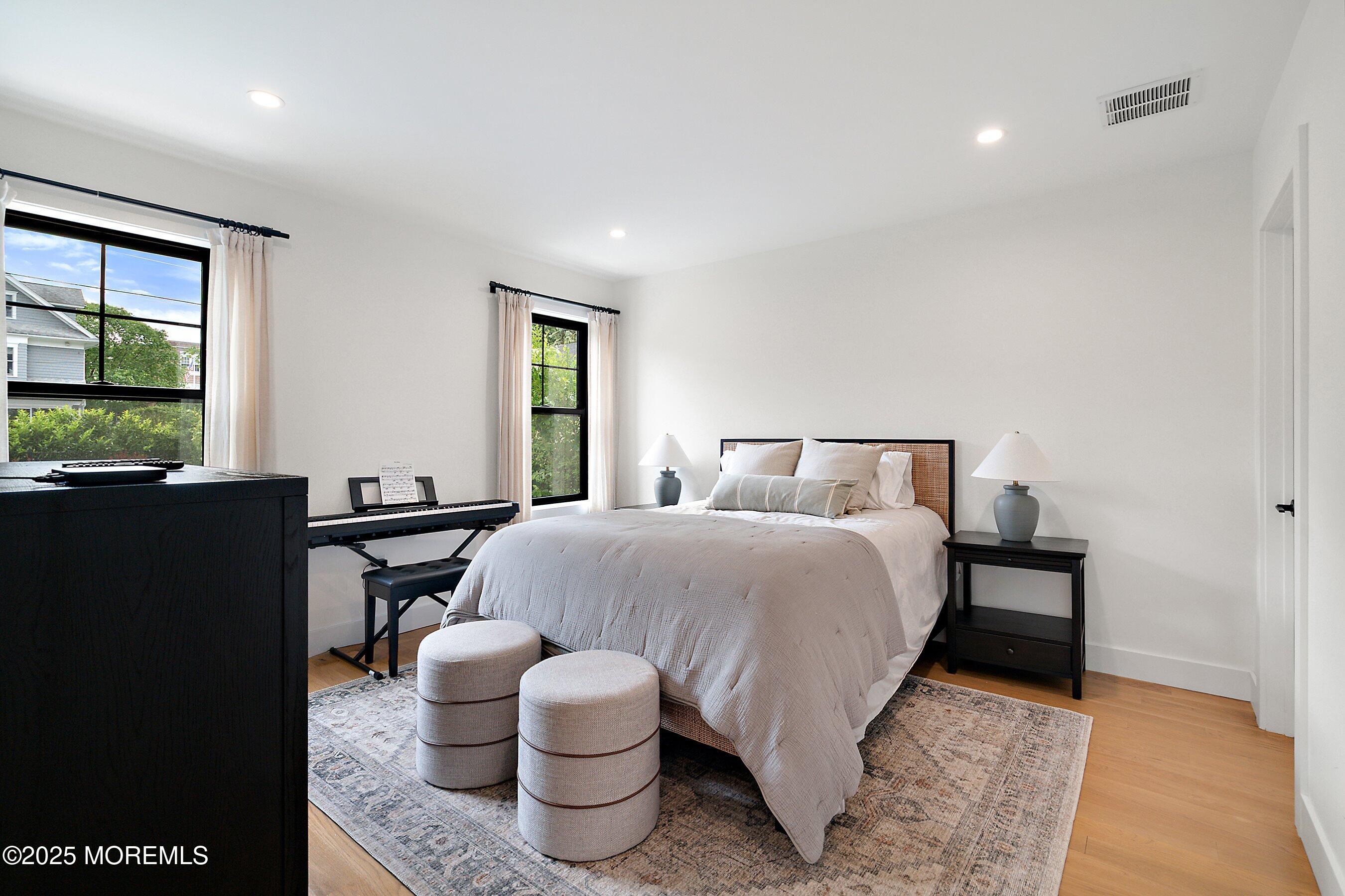 405 Ludlow Avenue Spring Lake, NJ 07762 - Photo 31 of 42 a bedroom with a bed and wooden floor