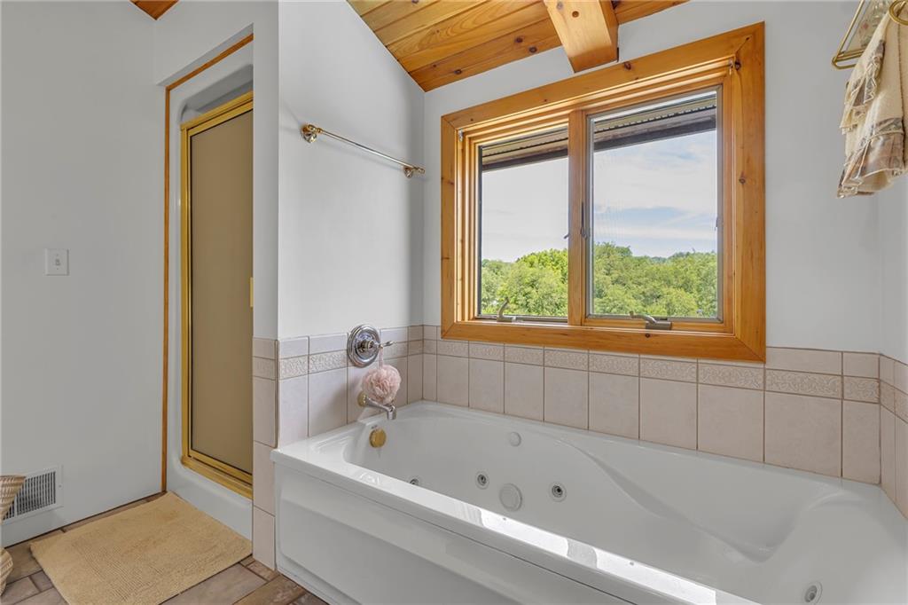 303 Sharon Grange Road Aliquippa, PA 15001 - Photo 26 of 50 Master bathroom featuring a full shower as well as a soaking jetted tub. Window over looks the pool area and rear yard.