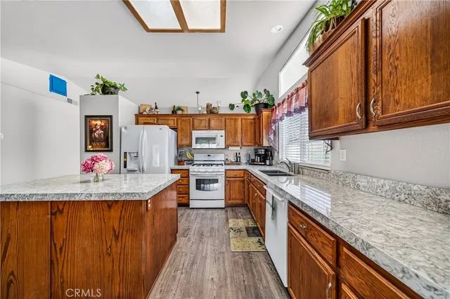 a living room with furniture a flat screen tv and wooden floor