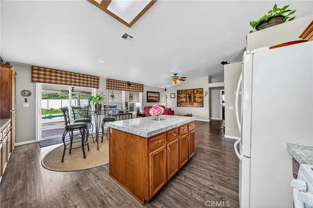 a living room with furniture a flat screen tv and a window