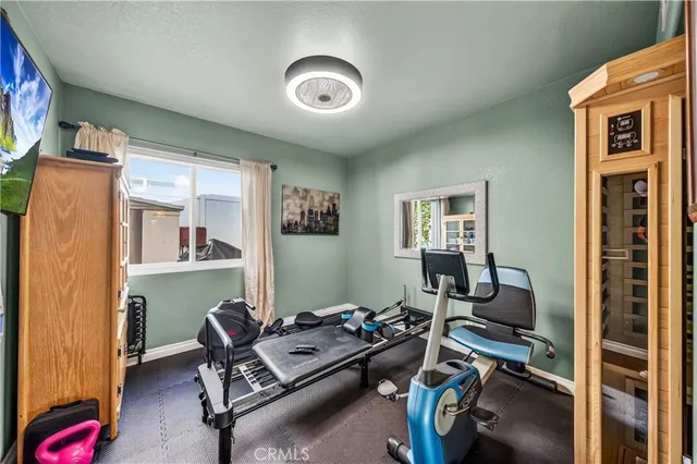 a bathroom with a granite countertop sink a toilet a mirror a bathtub and shower