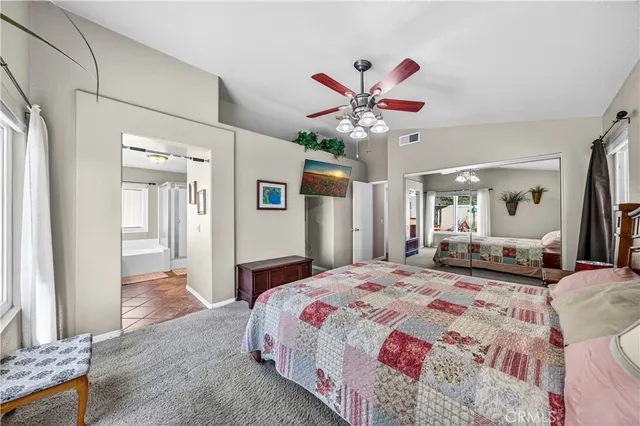 a bathroom with a granite countertop tub double vanity sink and mirror
