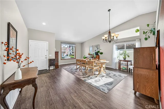 a kitchen with stainless steel appliances granite countertop a stove and a view of living room