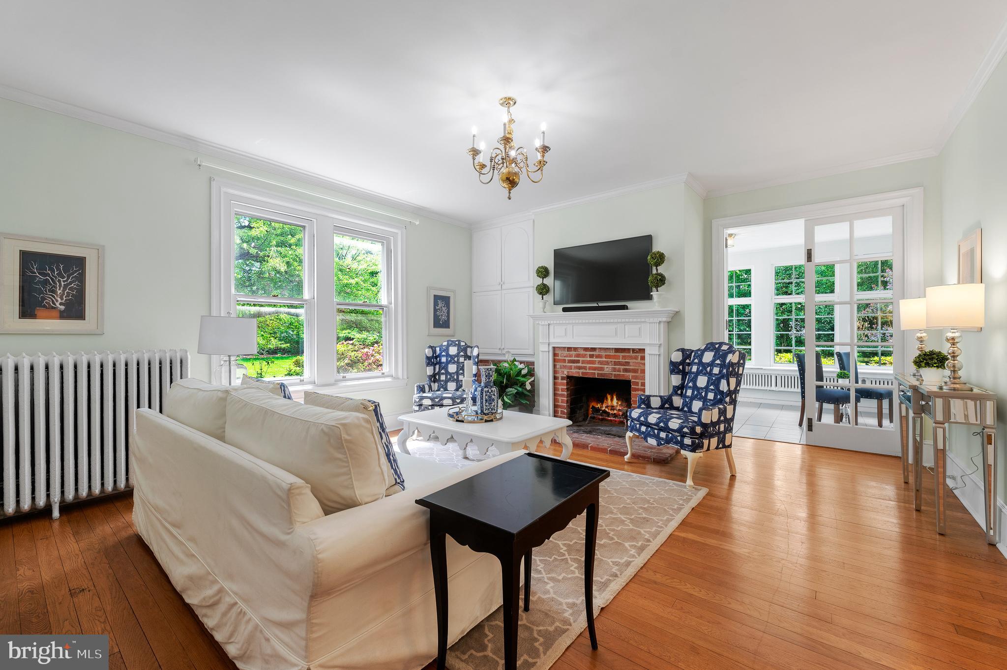 823 King Of Prussia Road Radnor, PA 19087 - Photo 14 of 71 a living room with furniture a fireplace a flat screen tv and a large window