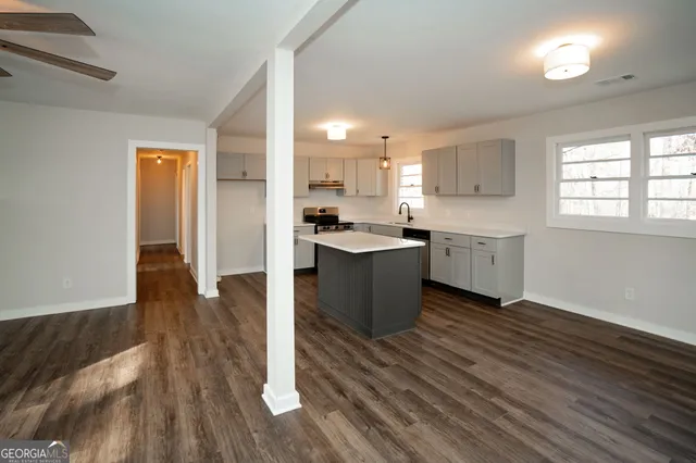 a view of a kitchen with wooden floor and staircase