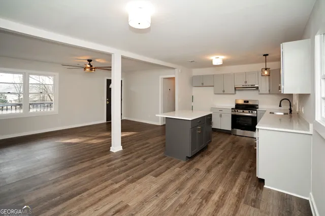 a view of a room with wooden floor and windows