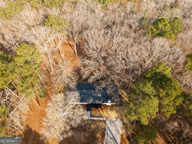 a view of a house with a yard covered in snow