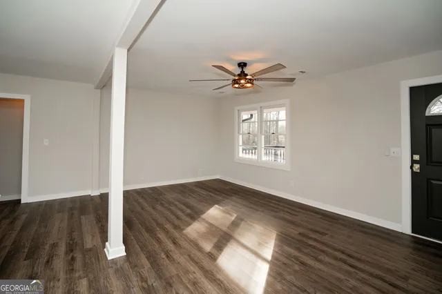 a kitchen with a sink cabinets stainless steel appliances and a window