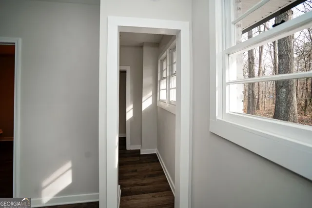 a spacious bathroom with double vanity a mirror a bathtub and a sink