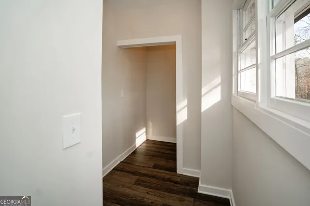 a view of hallway with wooden floor