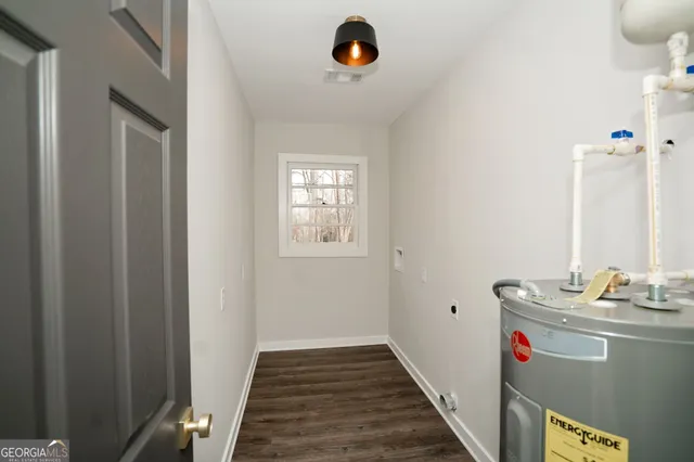 an empty room with wooden floor a ceiling fan and a window