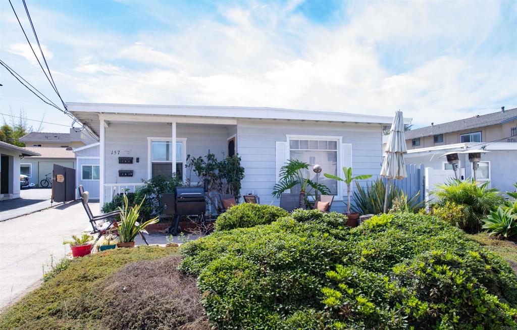 157 Maple Avenue Carlsbad, CA 92008 - Photo 2 of 16 a view of a house with potted plants and a bench