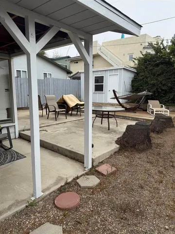 a view of a patio with table and chairs potted plants