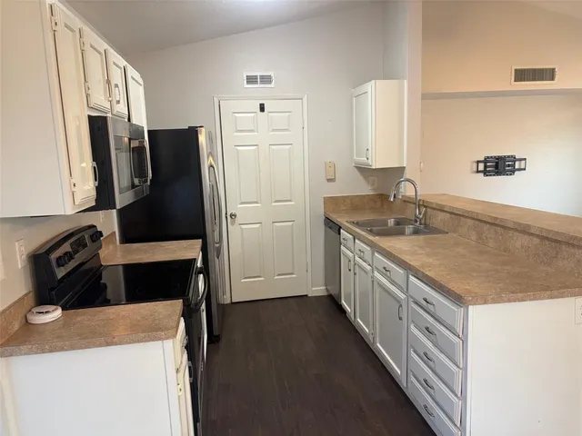 a kitchen with a refrigerator sink and stove