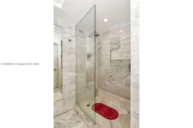 a bathroom with a shower and a sink