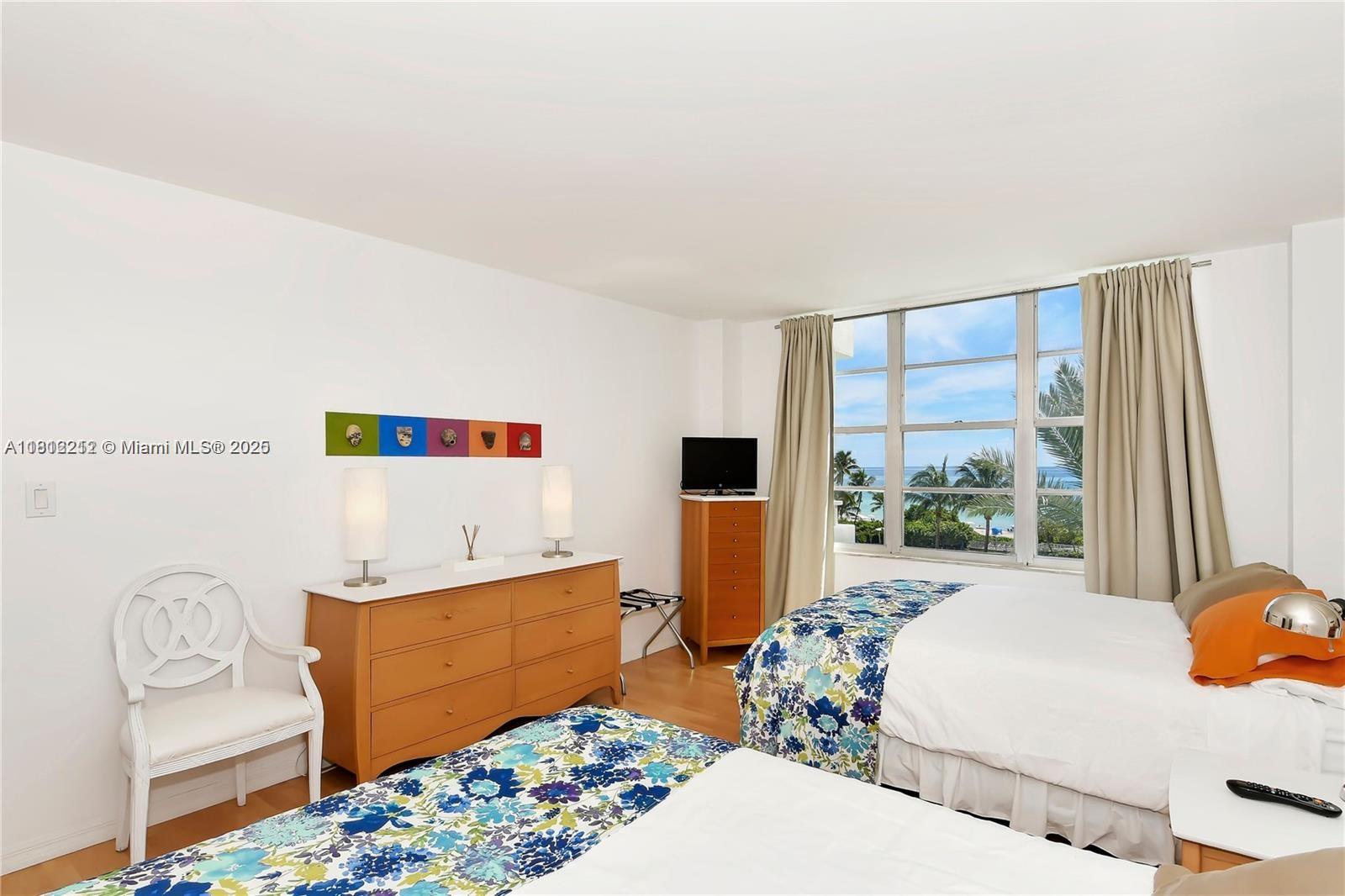 5151 Collins Avenue, Unit 619 Miami Beach, FL 33140 - Photo 15 of 16 a bedroom with furniture and a large window