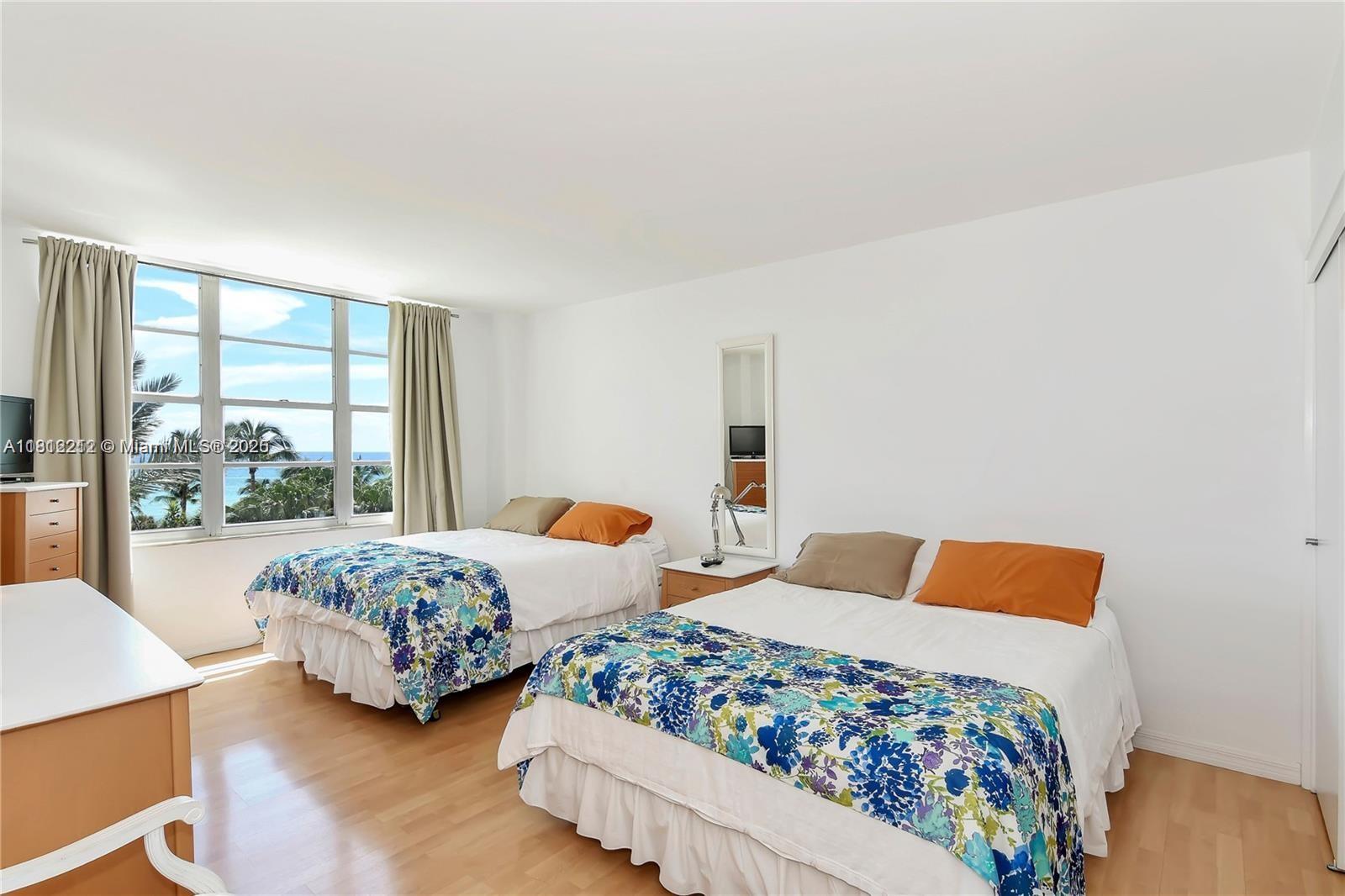 5151 Collins Avenue, Unit 619 Miami Beach, FL 33140 - Photo 16 of 16 a bedroom with two beds and large window